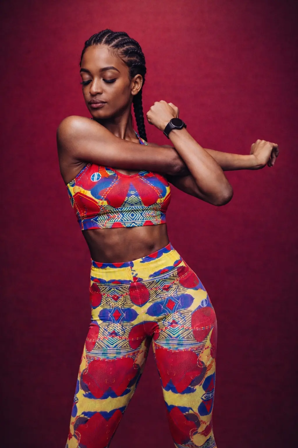 Athlete stretching in a colourful ALLEON sportswear set